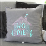 Ein Kissen wurde mit verschiedenen Flexfolien gestaltet. Abgebildet ist das Wortspiel "Home sweet Home" in rosa und türkisen Farbtönen.