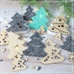 Abgebildet sind die verschiedenen Elemente der Mix'n Match "Lichttannen" - Kreativdatei. Die Tannen wurden aus Holz gelasert, aus Filz geschnitten und mit dem 3D Drucker gedruckt. Abgebildet sind verschiedene Größen.