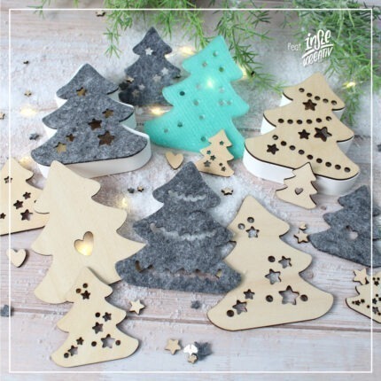 Abgebildet sind die verschiedenen Elemente der Mix'n Match "Lichttannen" - Kreativdatei. Die Tannen wurden aus Holz gelasert, aus Filz geschnitten und mit dem 3D Drucker gedruckt. Abgebildet sind verschiedene Größen.